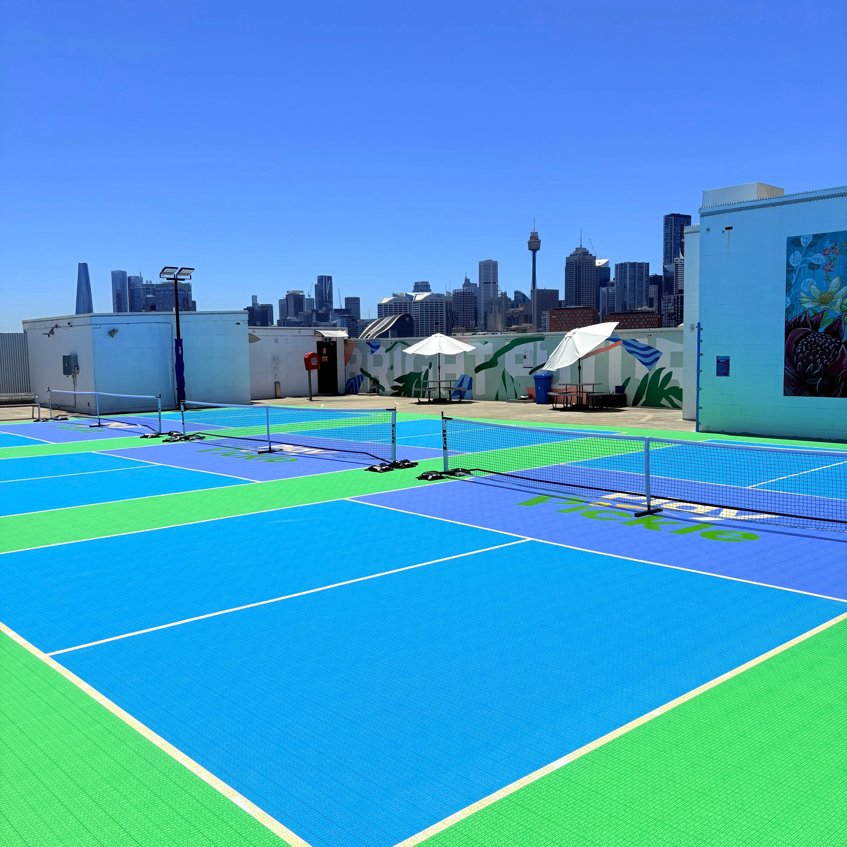 The rooftop courts at Broadway with the Sydney skyline behind