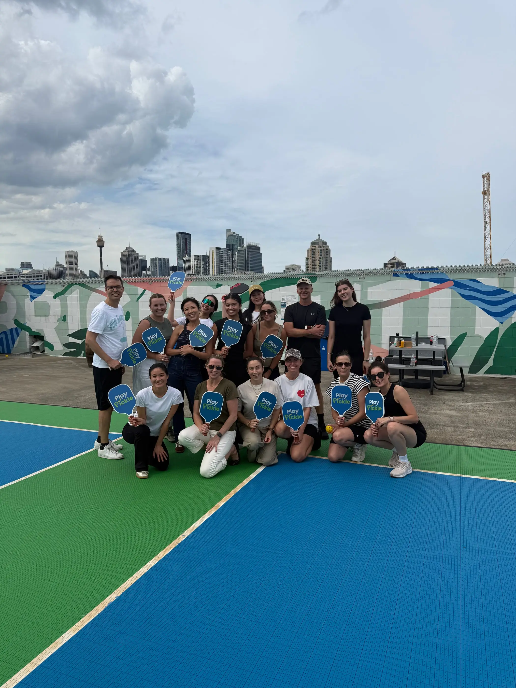 Players gathered on the rooftop courts at Broadway after a social pickleball session